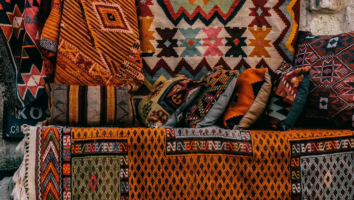 Ancient colorful patterns on rugs and soft cushions
