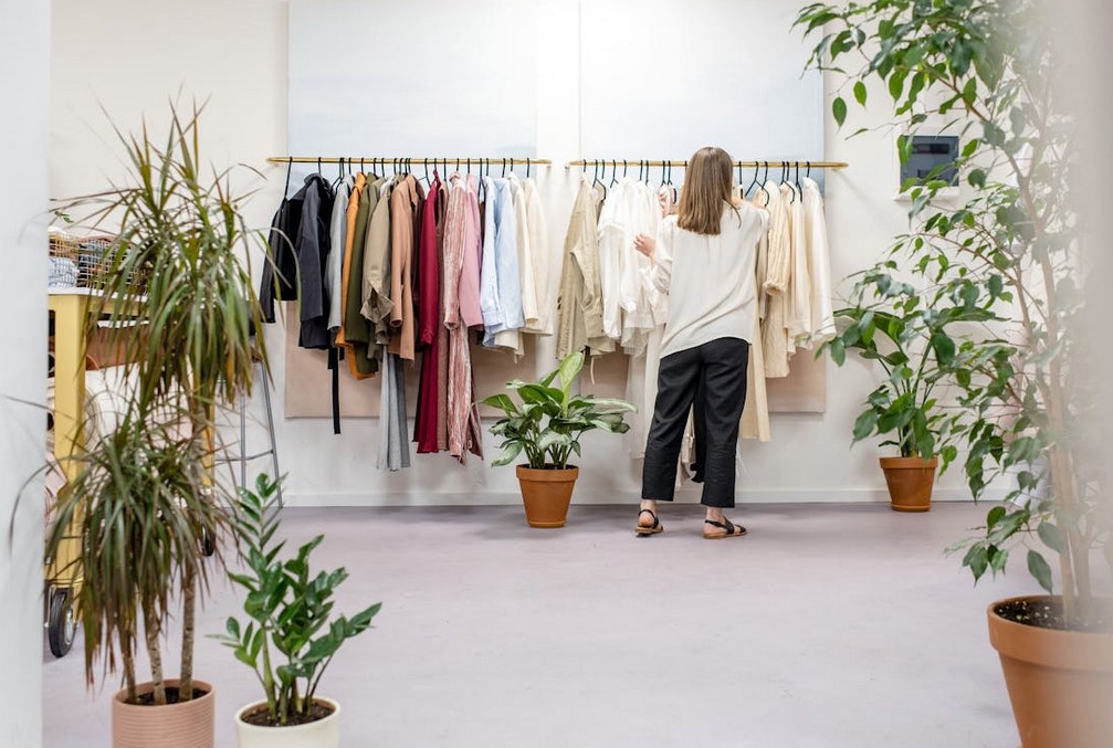 Woman in a boutique style interior looking through clothes
