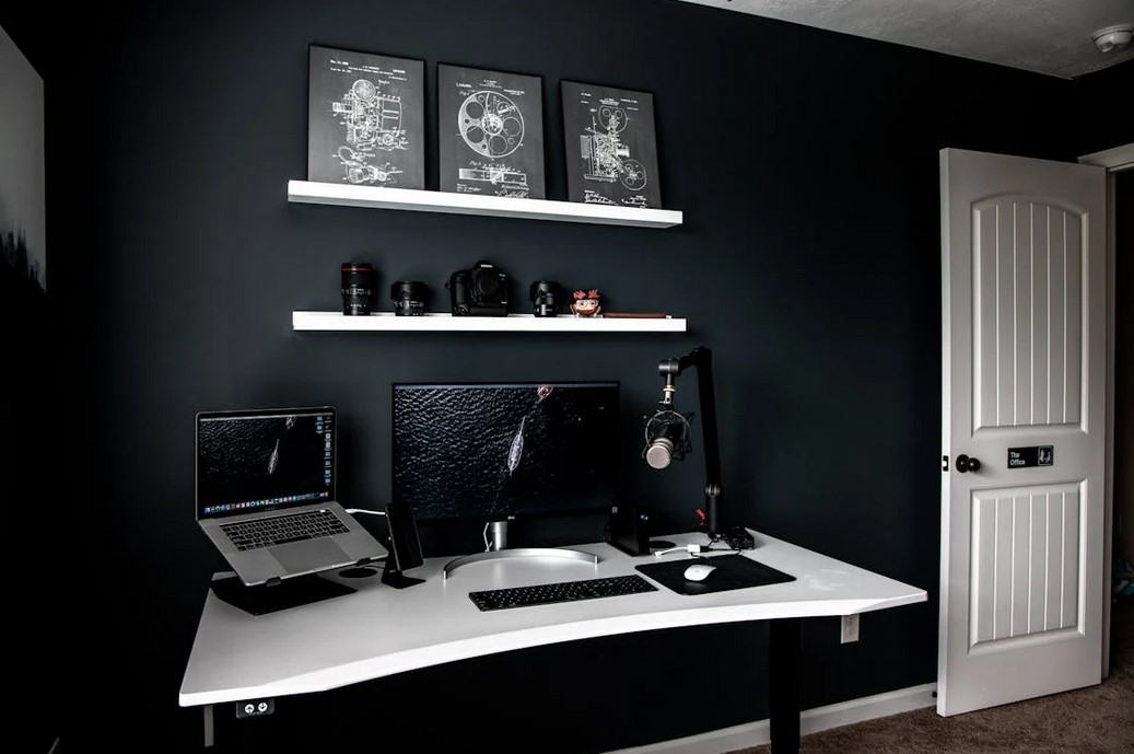 A home office with dark hues and light accent colors, computer and computer desk, great for den bedroom decorating ideas