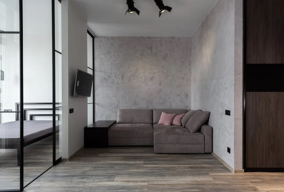 Modern bedroom with sectional sofa and glass room dividers
