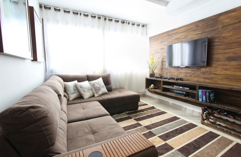 Small sized livingroom, brown furniture, daytime