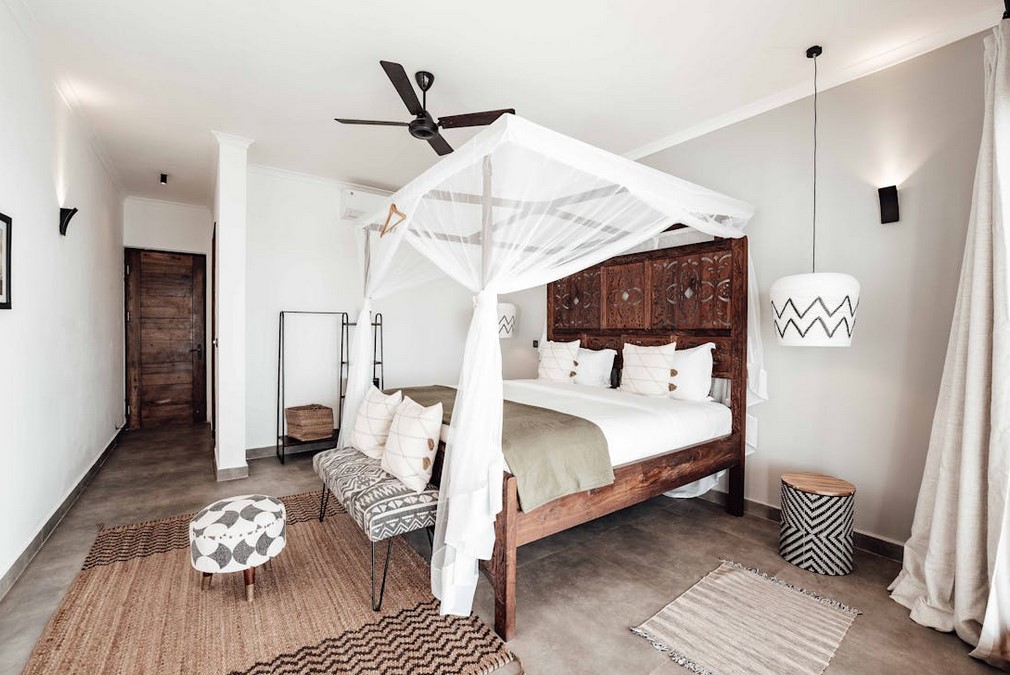 Stylish bedroom white with brown and tan accents, bed canopy