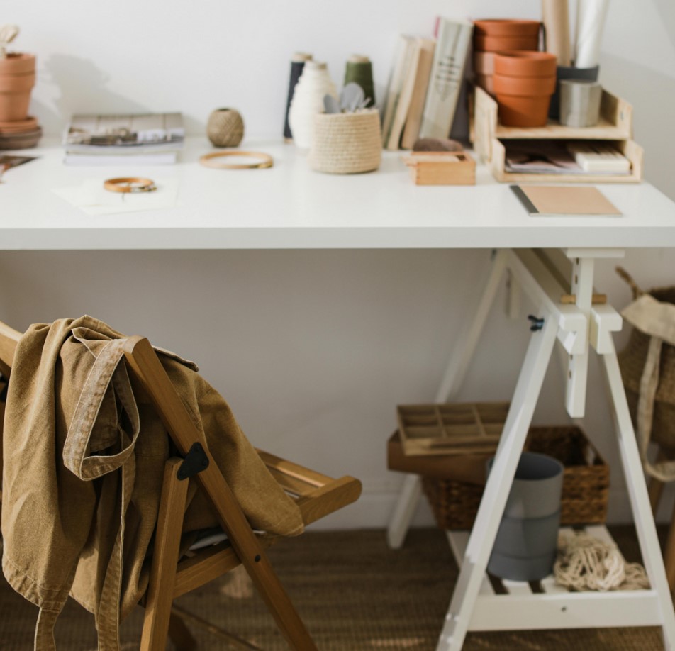 An adjustable white table and a wooden brown folding chair
