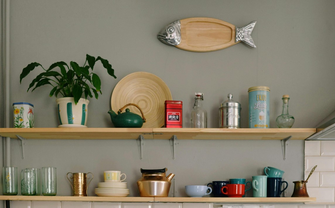 Floating wooden shelves in a kitchen with some decorations