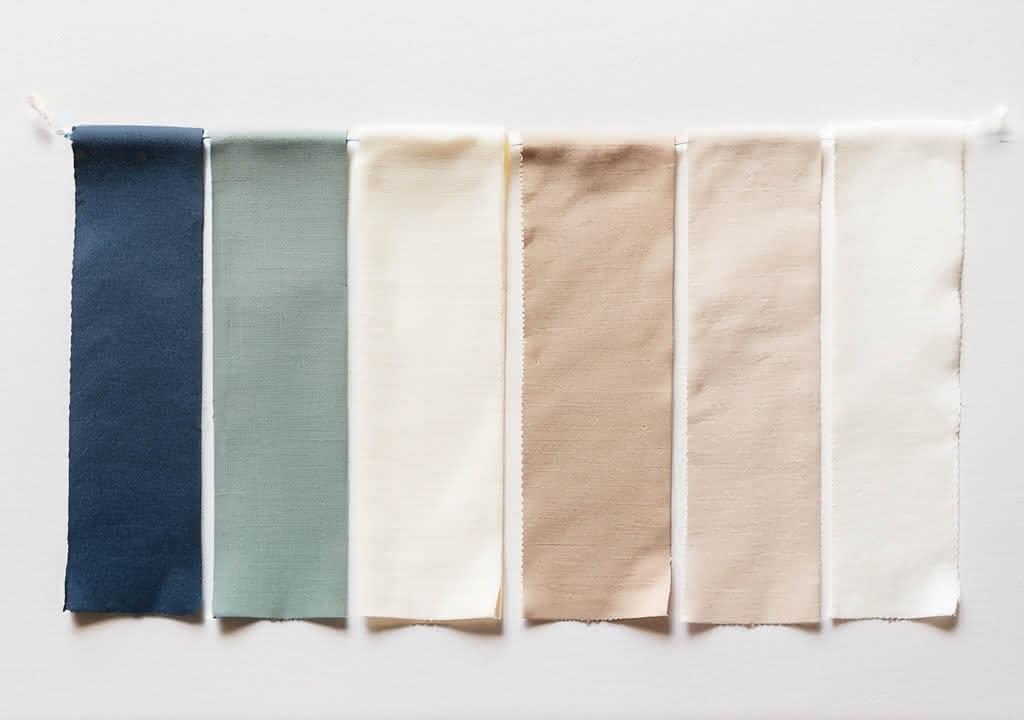 A collection of fabric color swatches, from dark shades to very light shades