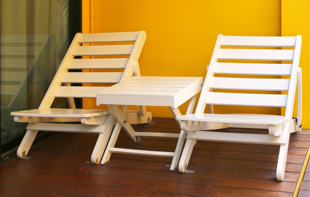 A pair of wooden foldable wooden changes and small foldable table