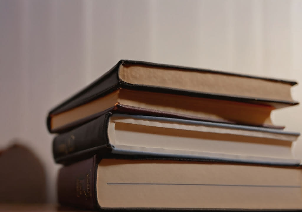 A stack of various books in a low angle shot